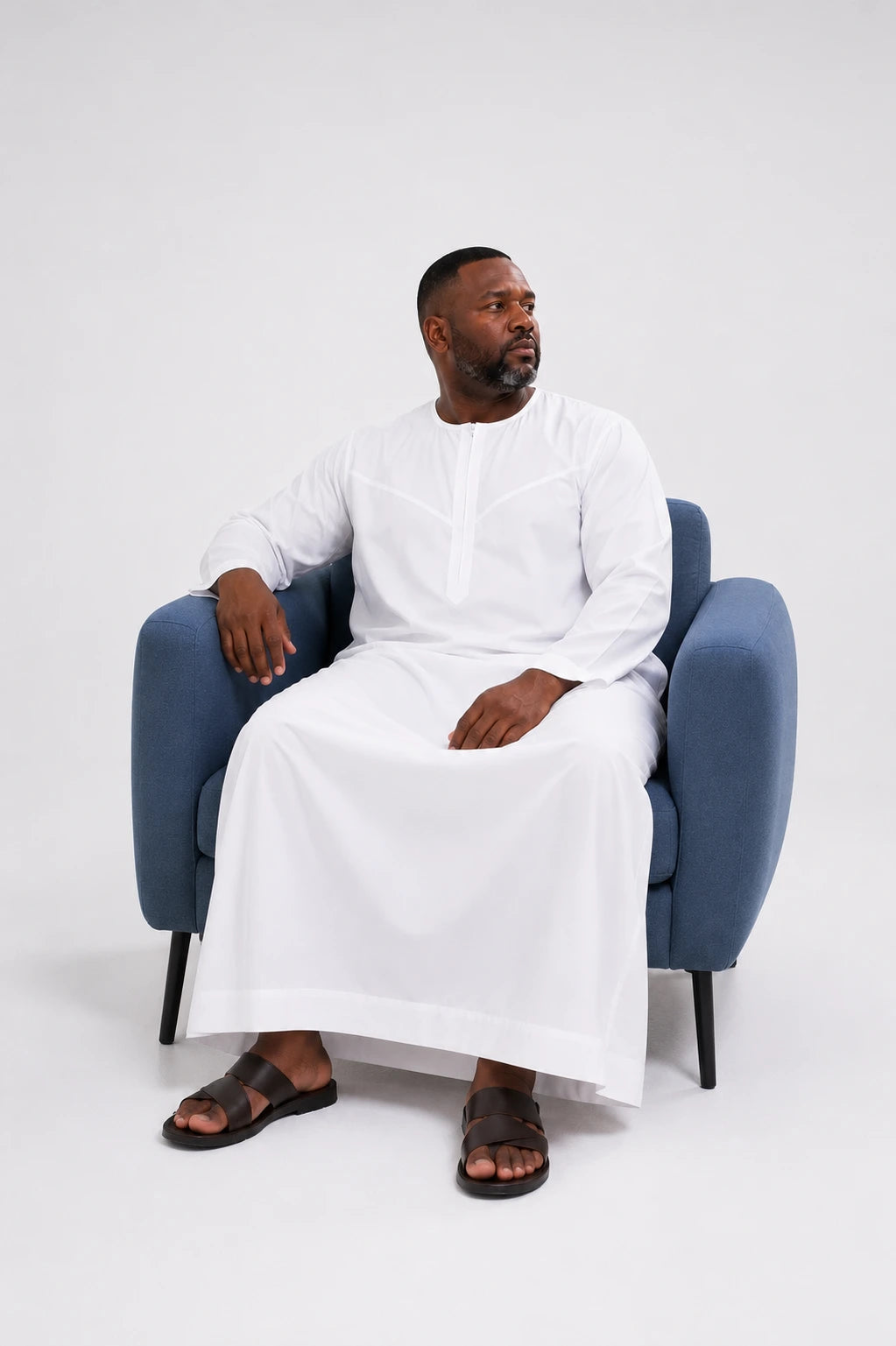 Man seated wearing the white Japanese Toray thobe — relaxed, featherlight fit